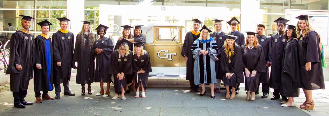 Excel graduate students posing in front of the GT Rambing Wreck